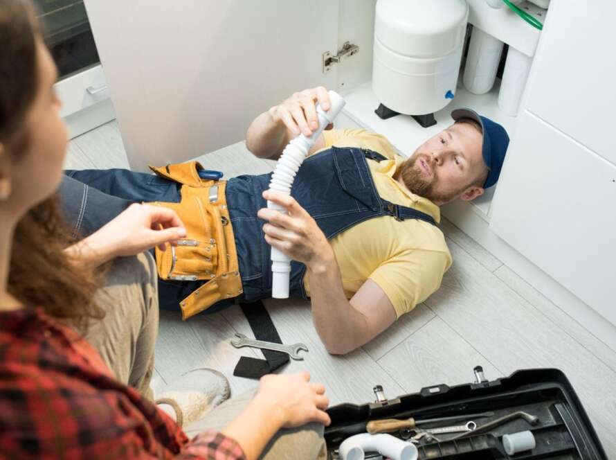 A plumber fixing a sink.