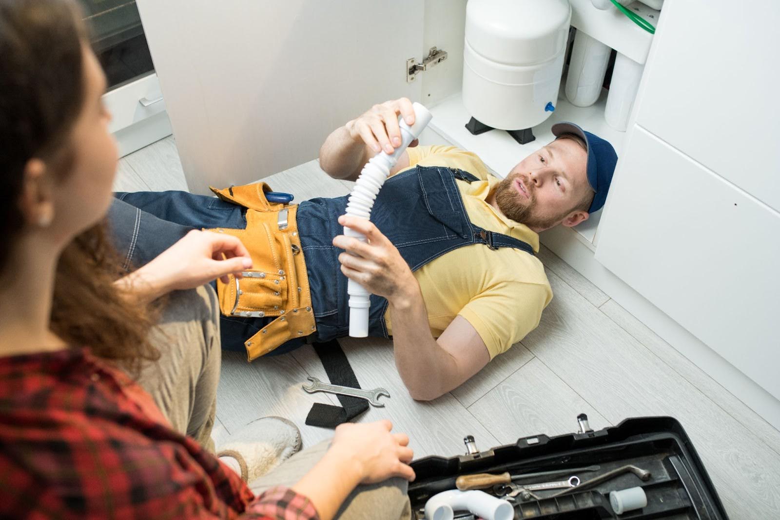 A plumber fixing a sink.