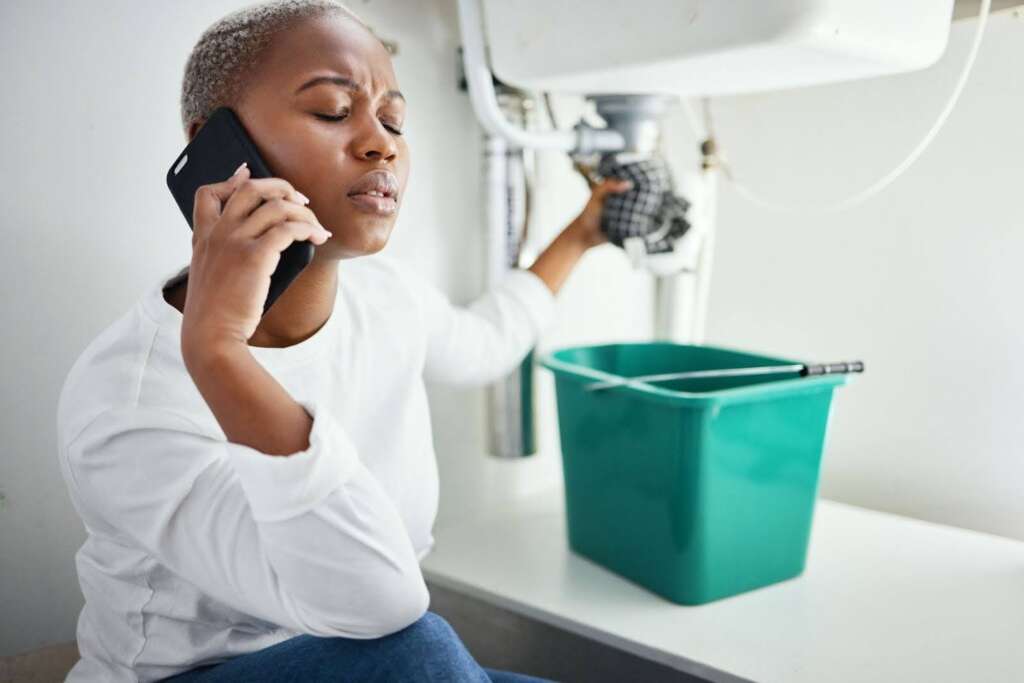 A woman calling the plumber for an emergency.