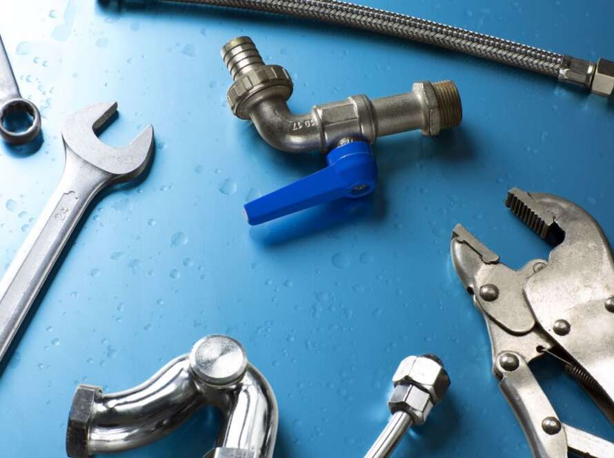 A set of plumbing tools on the table.