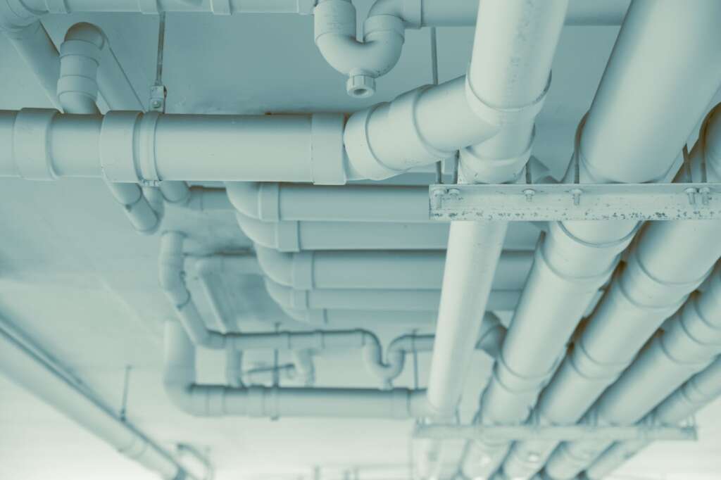 Commercial water and drain pipes installed in a modern building system.